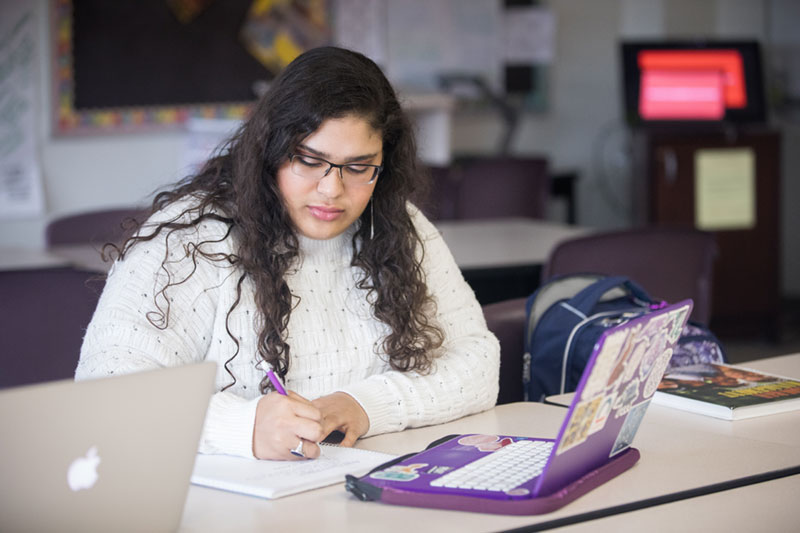 English Student working on paper.