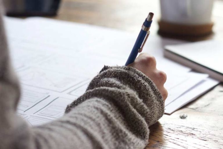 Hand writing on paper with pen