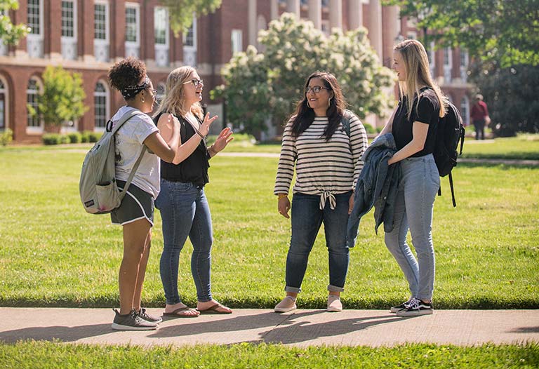 Undergraduate Students Talking in front of Johnson Hall.