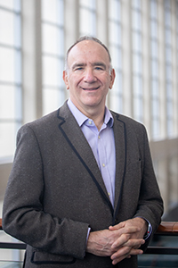 male wearing grey suit and lavender shirt